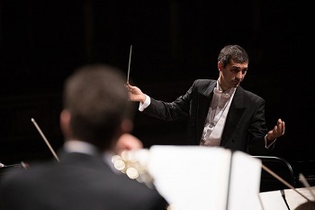 A director holds a baton to direct an orchestra